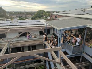 Students pointing at rooftop solar